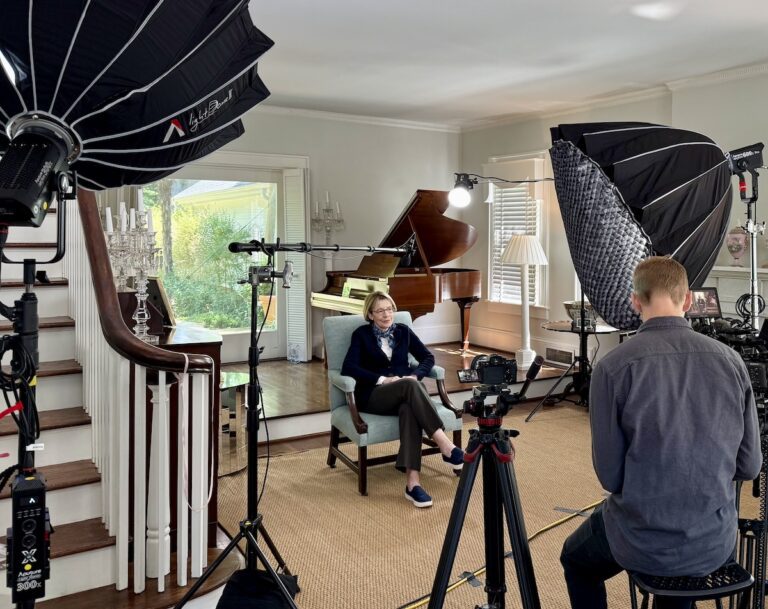 Behind-the-scenes view of a B2B video interview in progress, with subject mid-conversation in soft professional lighting